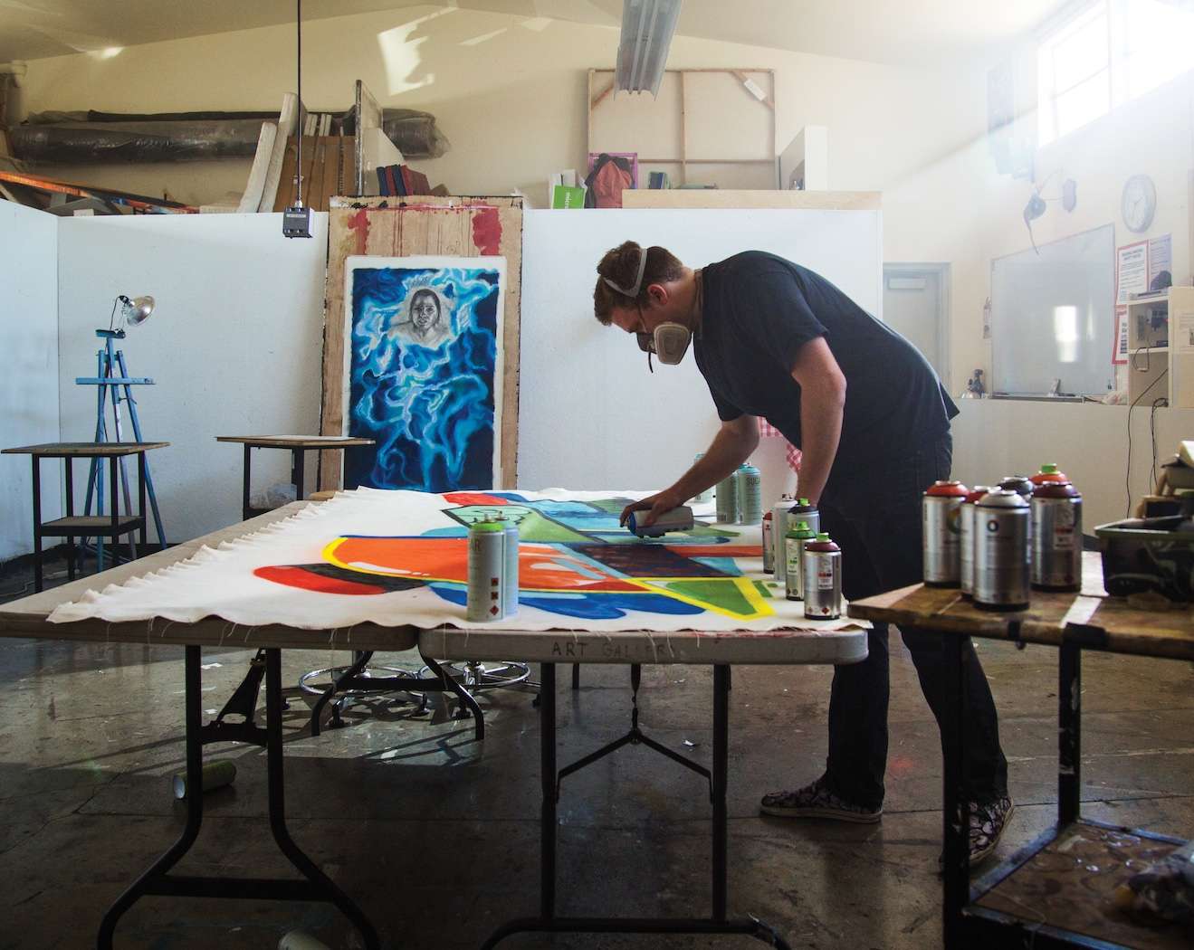 Photo of art student spraypainting